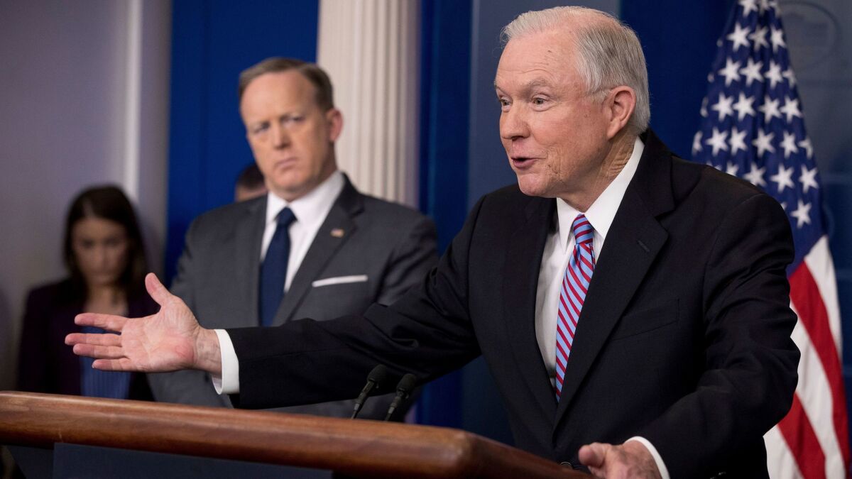 Attorney General Jeff Sessions, right, talks to the media during the daily press briefing at the White House in Washington on March 27.