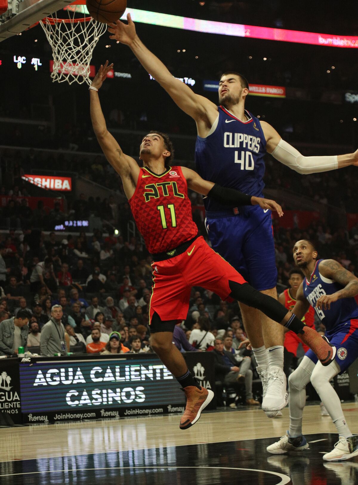 Hawks guard Trae Young has his shot challenged by Clippers center Ivica Zubac.
