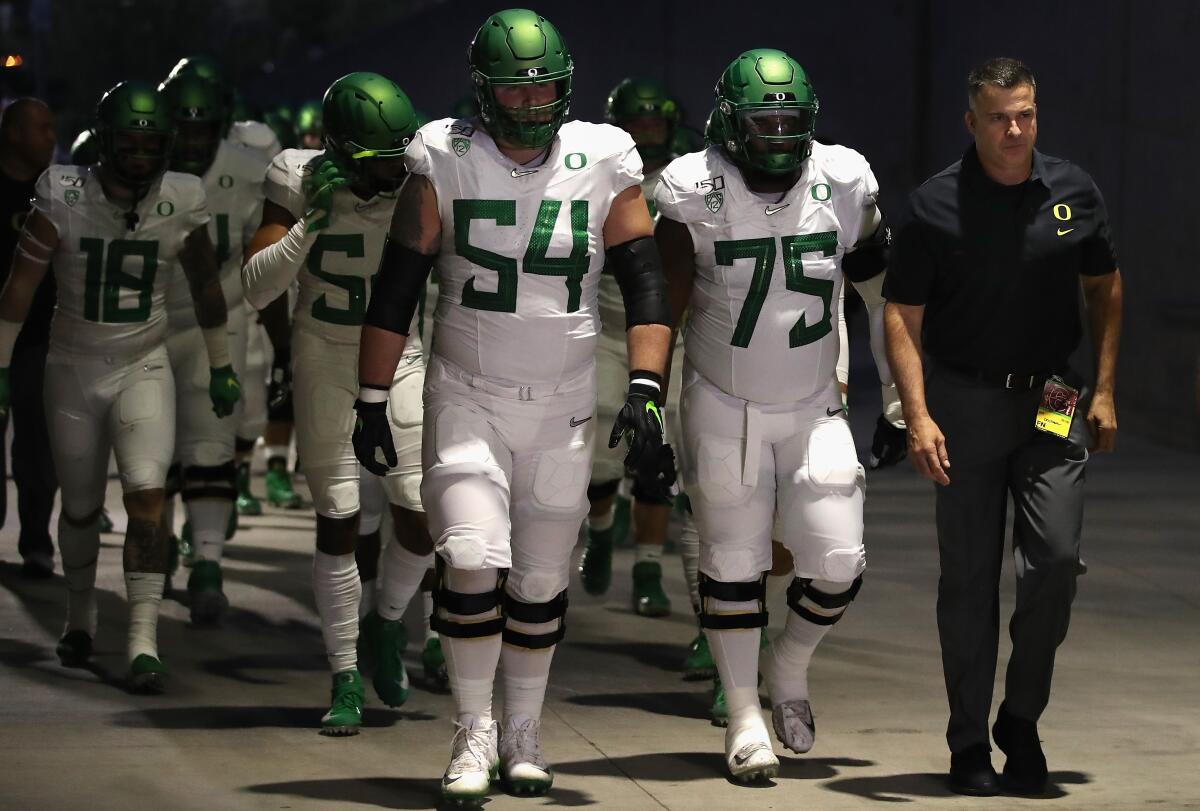 Oregon coach Mario Cristobal leads the Ducks to the field before a game against Arizona State on Nov. 23 at Sun Devil Stadium.