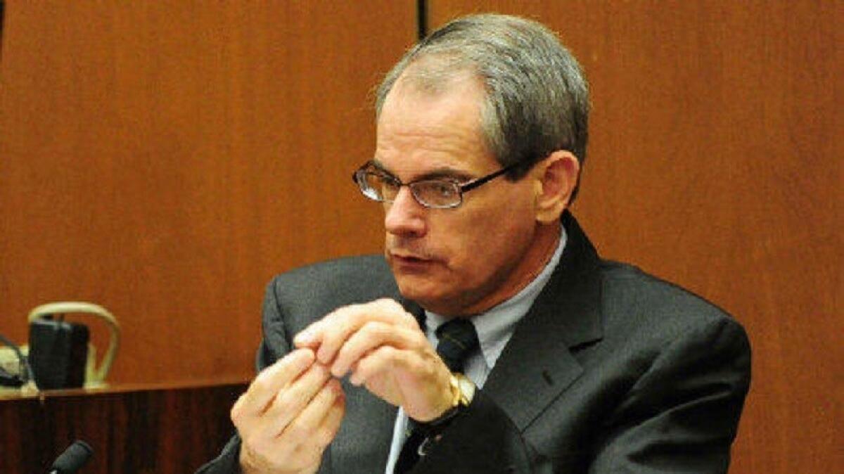 Dr. Christopher Rogers, the newly named acting chief medical examiner-coroner at the Los Angeles County coroner's office, testifies in the 2011 manslaughter trial of Dr. Conrad Murray, Michael Jackson's physician.