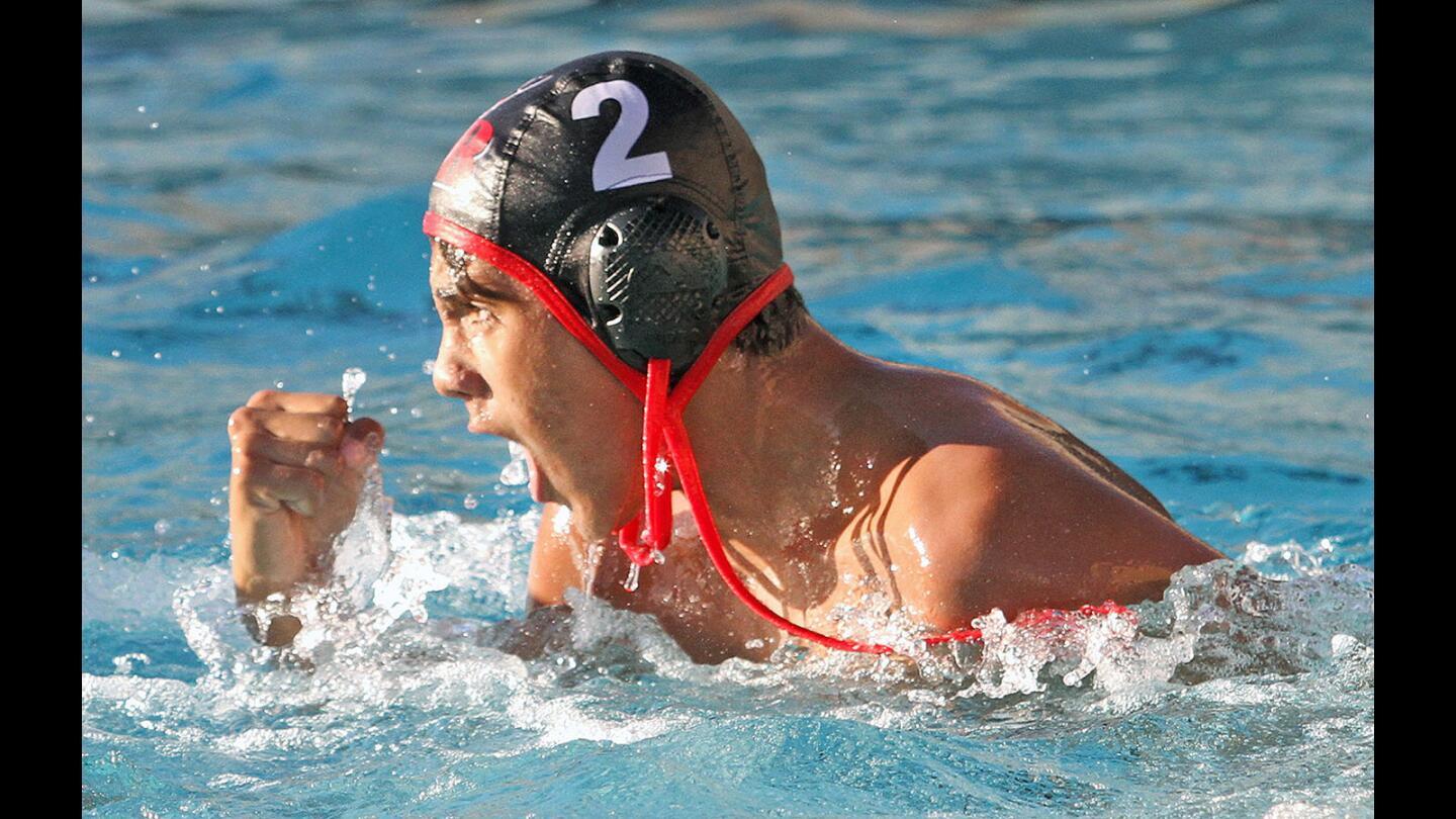Burroughs' Marko Vucetic pumps his fist after scoring against Atascadero in a CIF Southern Section Division IV wildcard water polo match at Burroughs High School on Tuesday, November 10, 2015. Burroughs win the match 14-11 and will play next in Santa Monica. (Tim Berger/Staff Photographer)