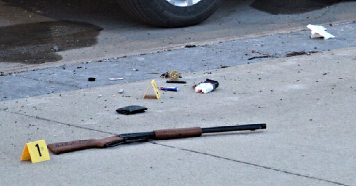 Items on the sidewalk at the scene of an officer-involved shooting at the foot of the Sixth Street bridge early Wednesday, April 7, 2021, in Waterloo, Iowa. In a lawsuit filed Thursday, Sept. 23, 2021, a man who was paralyzed when an Iowa police officer shot him in April is suing the officer. Marcelino Alvarez-Victoriano contends the shooting was not justified. Authorities say a Waterloo police officer shot Alvarez-Victoriano after he pointed a pellet gun that looked like a shotgun at two Black Hawk County sheriff's deputies. (Jeff Reinitz/The Courier via AP)