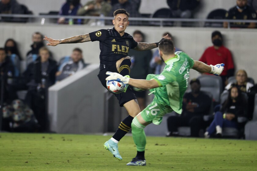 LAFC forward Brian Rodriguez challenges Vancouver Whitecaps goalkeeper Maxime Crepeau.