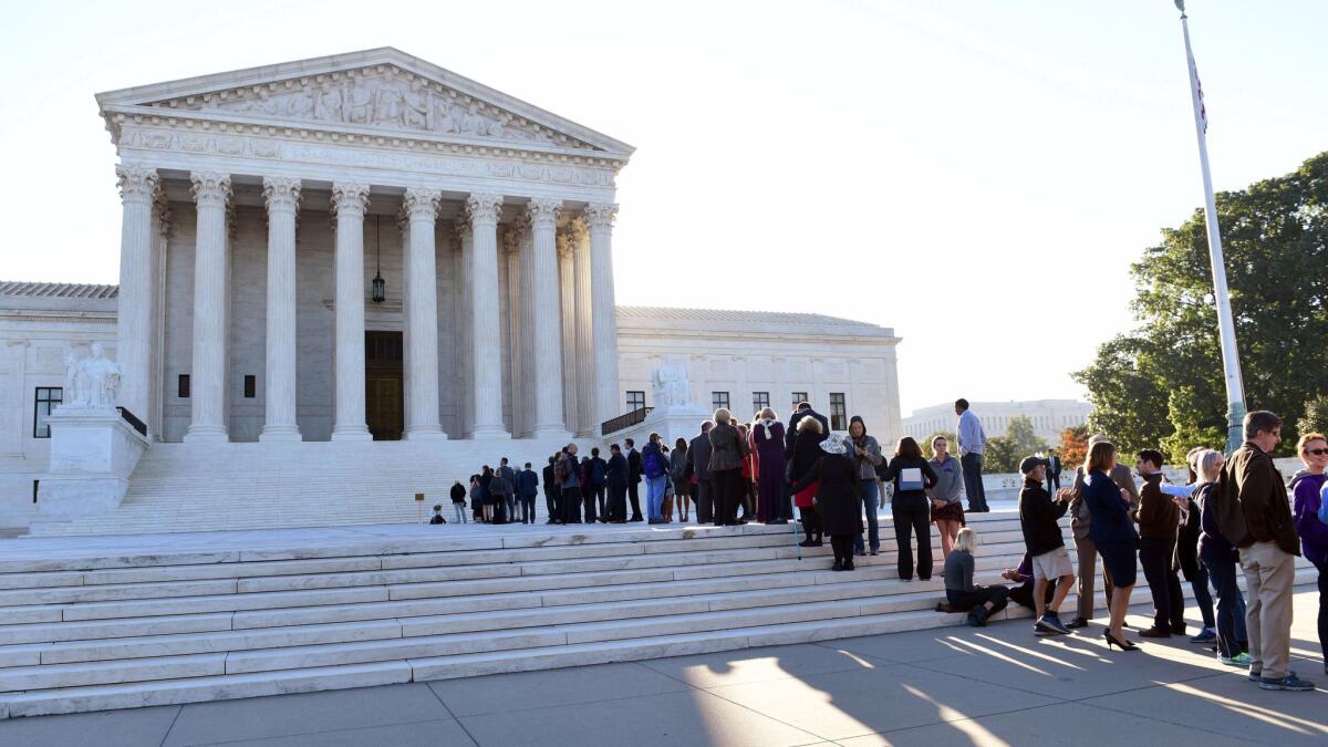 People stand in line to enter the Supreme Court for the first day of the new term in Washington on Oct. 2.