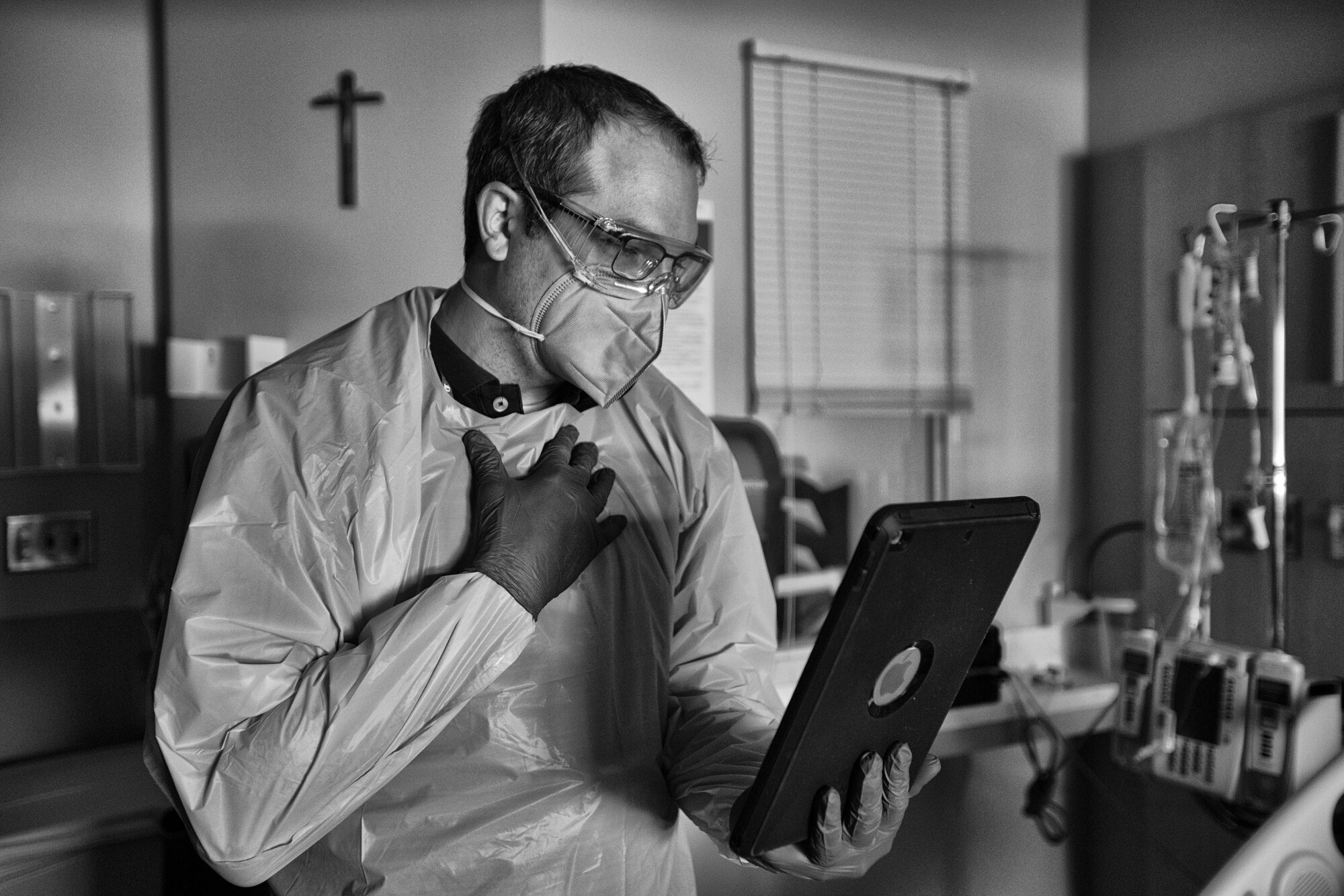 The fight against COVID, a chaplain says, unfolded on 'sacred ground' 3 Chaplain Kevin holding an iPad during a video chat