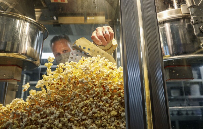 Jimmy Pater, scoops popcorn at Cinepolis Luxury Cinemas Del Mar in March. 