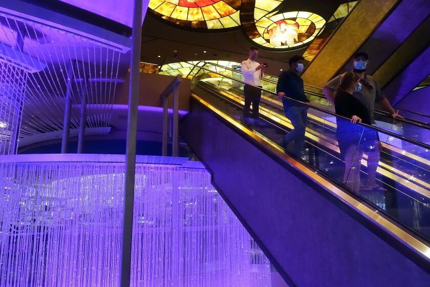LAS VEGAS, CA - JULY 06: People are seen on escalators at the Cosmopolitan Hotel on Monday, July 6, 2020 in Las Vegas, CA. At least 20 Cosmopolitan employees have tested positive for COVID-19 and employees no longer feel safe going to work there. (Dania Maxwell / Los Angeles Times)