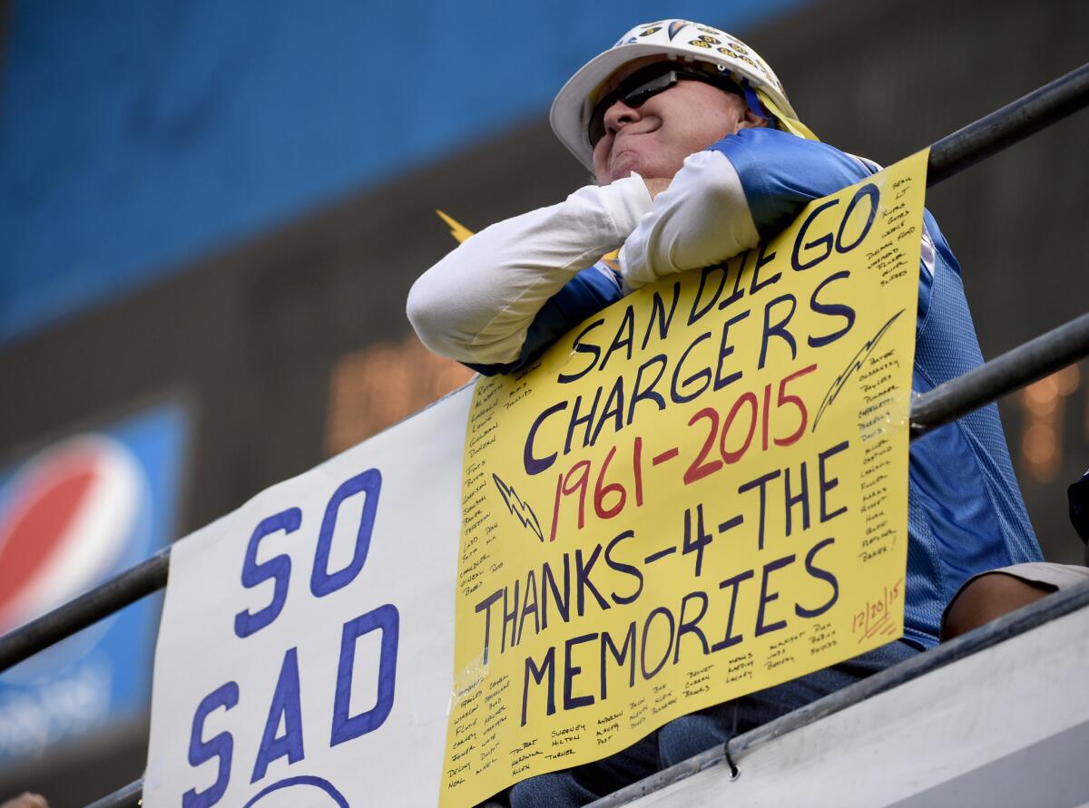 A fan holds up a sign on Dec. 20 commenting on the possible move by the San Diego Chargers.