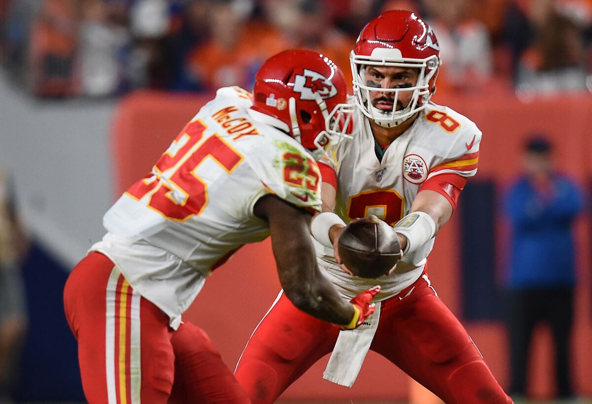 Kansas City Chiefs quarterback Matt Moore (8) hands off to running back LeSean McCoy (25) during the second half against the Denver Broncos on Thursday. Moore was an assistant coach with Hart when the Chiefs convinced him to return to the NFL.
