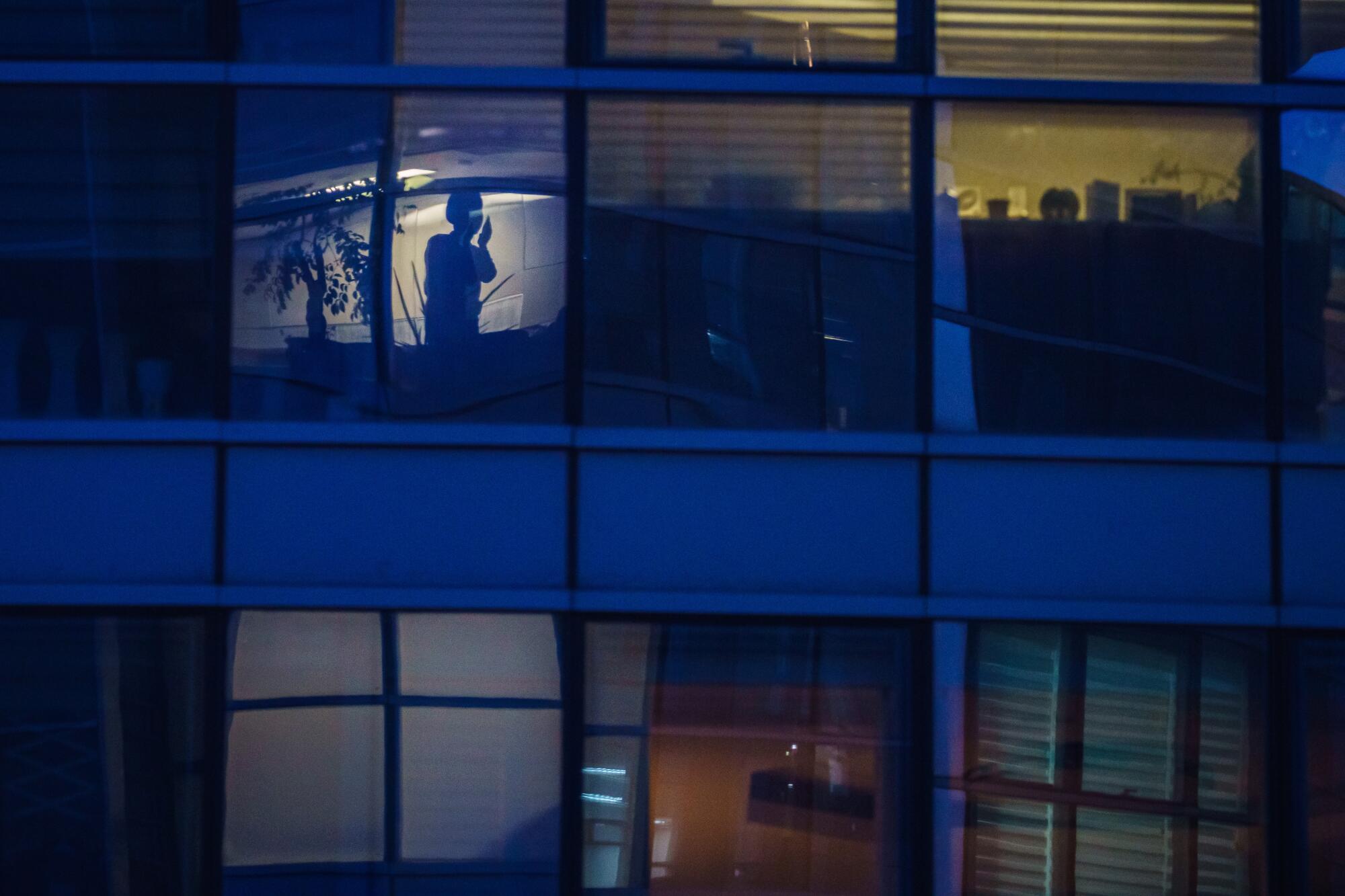 Apartment buildings light up in the evening as people return home from work in Seoul