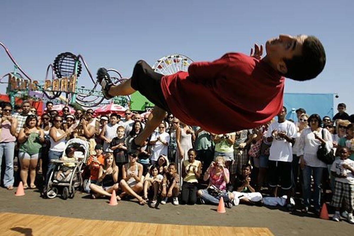 Lanny Markasky of the street dance group Mala Vida participates in a tumbling exercise at the Santa Monica Pier.