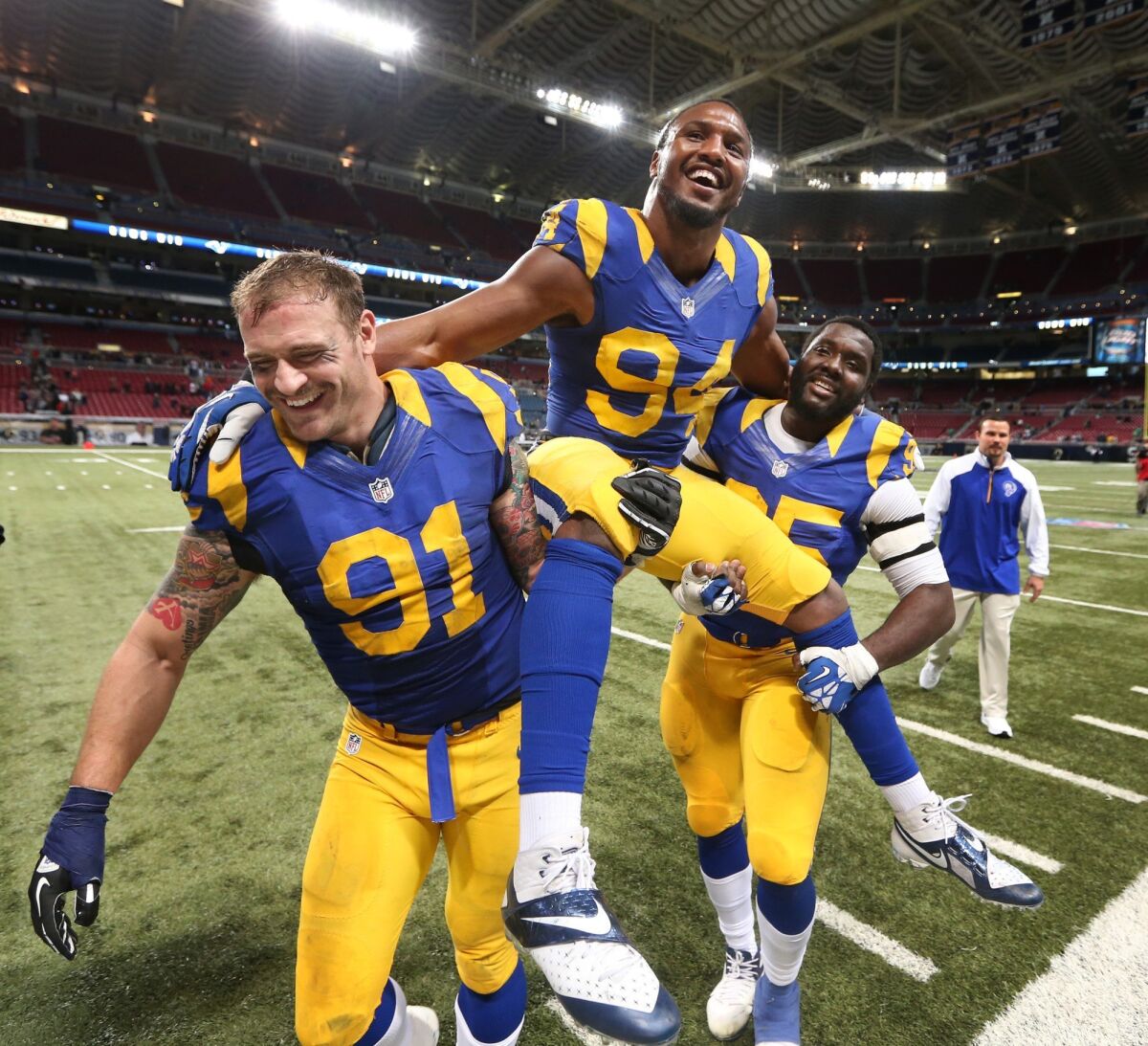 St. Louis Rams defensive end Robert Quinn is carried off the field by fellow defensive ends Chris Long, left, and William Hayes after setting the franchise single-season sack record at 18, following an NFL football game against the Tampa Bay Buccaneers on Sunday, Dec. 22, 2013, in St. Louis. The Rams won 23-13. (AP Photo/St. Louis Post-Dispatch, Chris Lee) EDWARDSVILLE OUT ALTON OUT The Associated Press