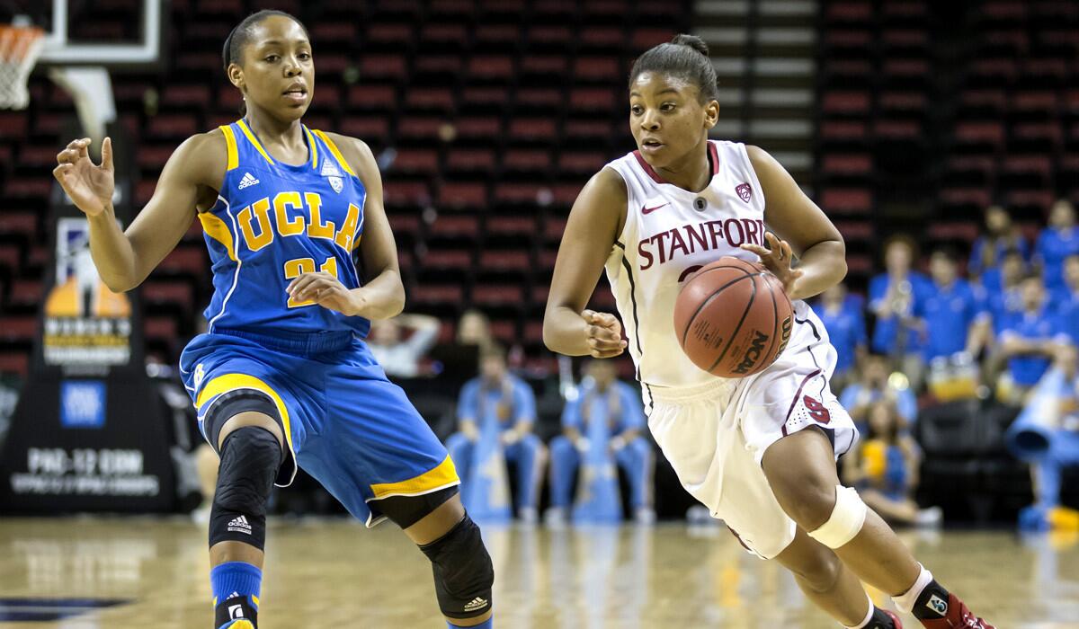 Stanford's Amber Orrange, right, dribbles the ball up court as UCLA's Nirra Fields defends during the Cardinal's 67-62 victory over the Bruins.