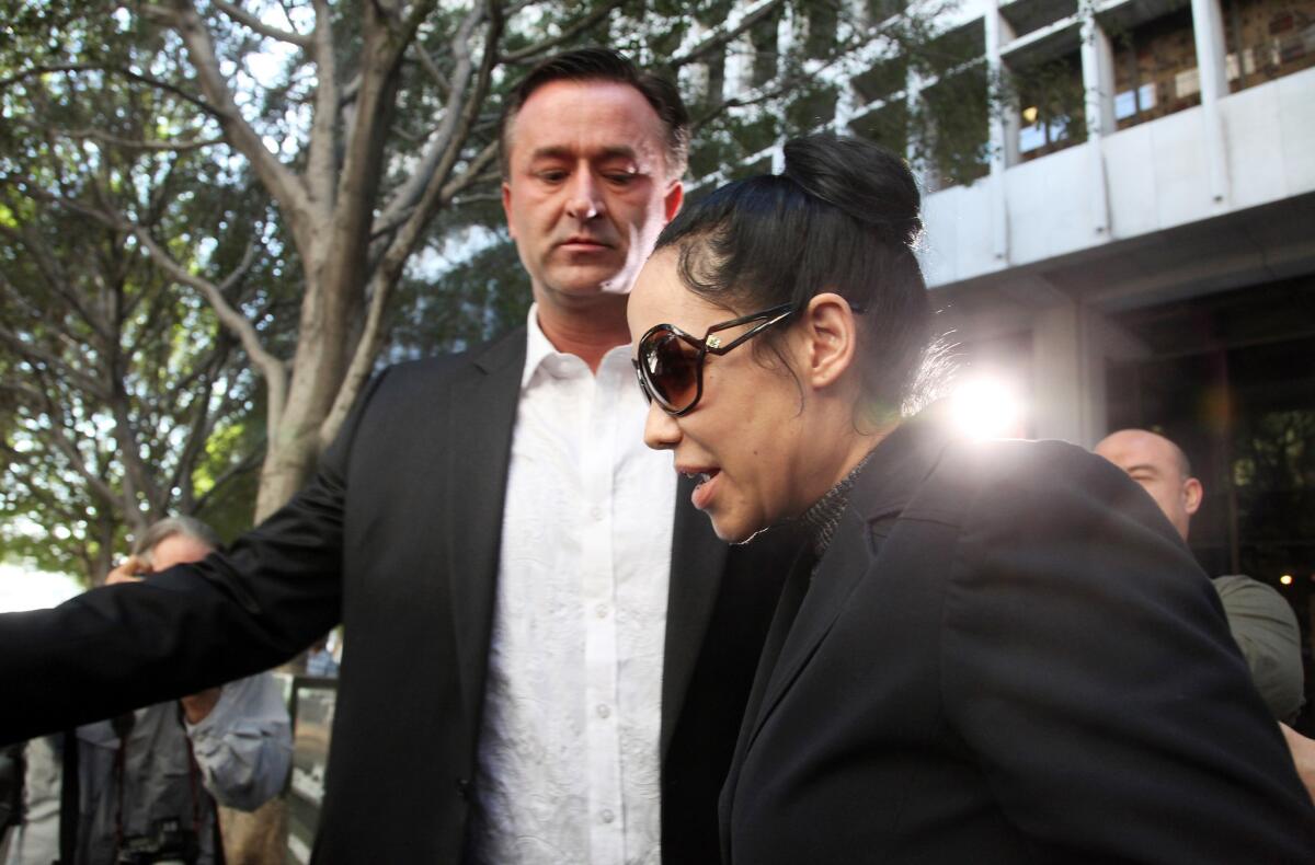 Nadya Suleman leaves Los Angeles County Superior Court with her attorney after she pleaded not guilty to welfare fraud charges. Those charges have been amended with an additional count of fraud.