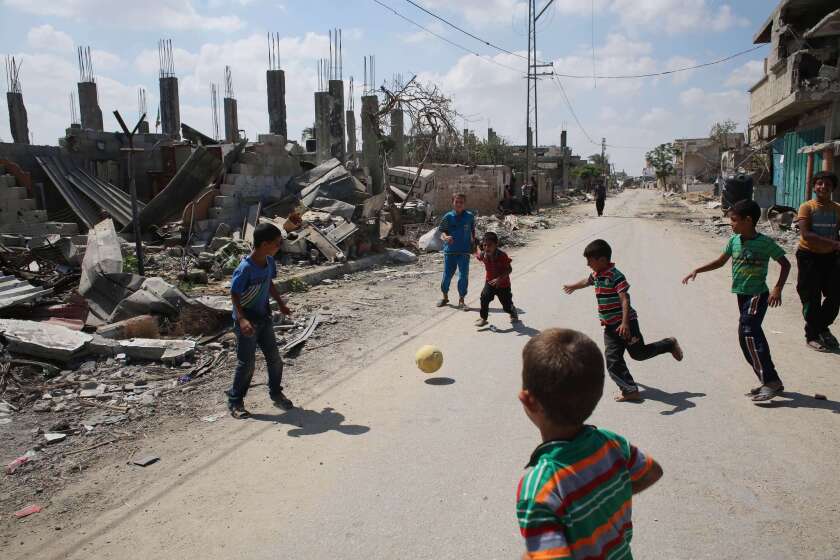 Palestinian children play near a destroyed house in Khan Yunis in the southern Gaza Strip on Sept. 11.