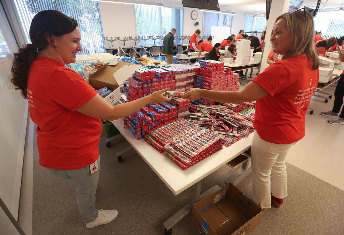 Volunteers fill hygiene kit boxes at the company headquarters in Irvine.