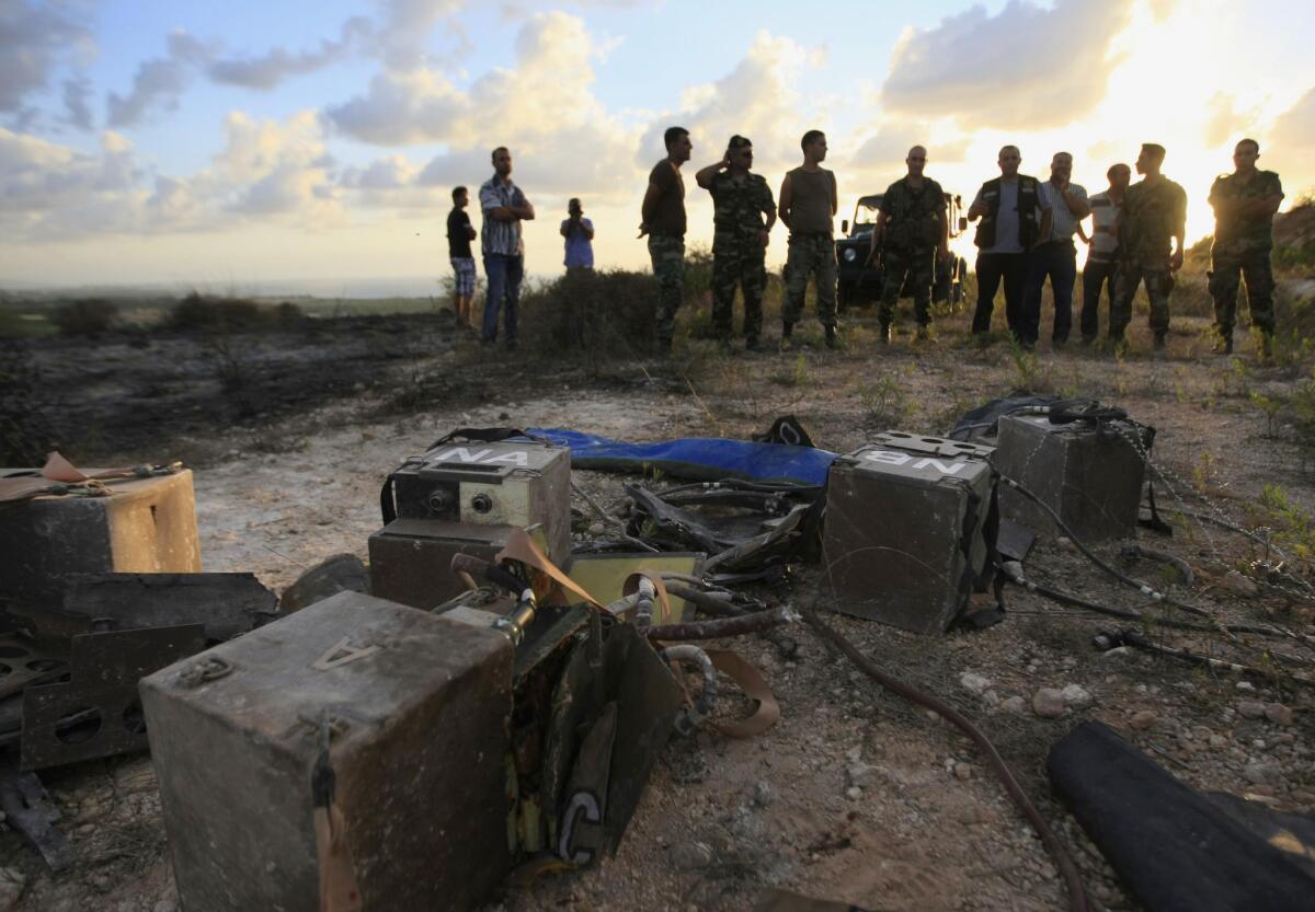 In a file photo from Sept. 5, Lebanese army soldiers inspect what they said were destroyed parts of an Israeli spying device planted in Adloun village, south Lebanon. Tensions heightened Sunday with the latest incident of cross-border shooting.