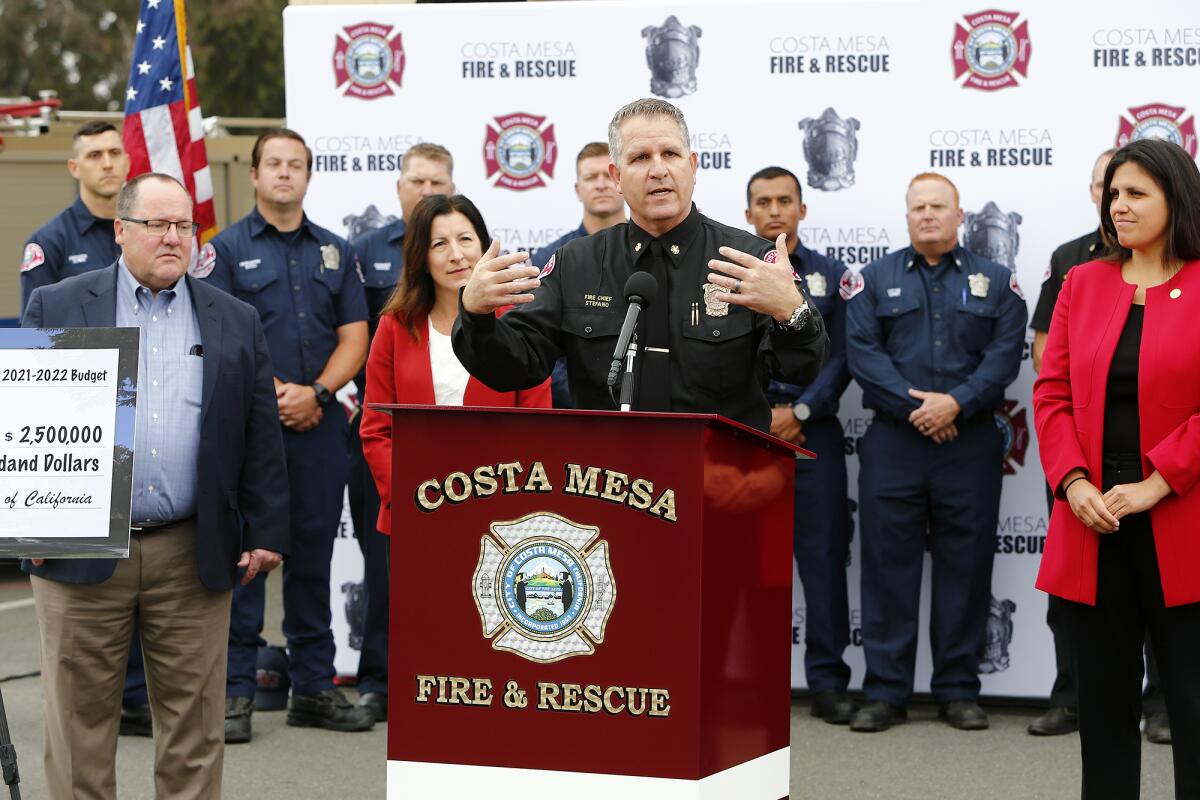 Costa Mesa Fire Chief Dan Stefano, center, speaks during an event at the city's Station No. 4 in June.
