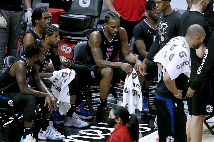 LOS ANGELES, CA - MAY 25: LA Clippers forward Kawhi Leonard (2) sits with teammates during a timeout in a game against the Dallas Mavericks in the fourth period at the Staples Center on Tuesday, May 25, 2021 in Los Angeles, CA. Game two of the NBA Western Conference first-round playoff series. Clippers lose 121-127. (Gary Coronado / Los Angeles Times)