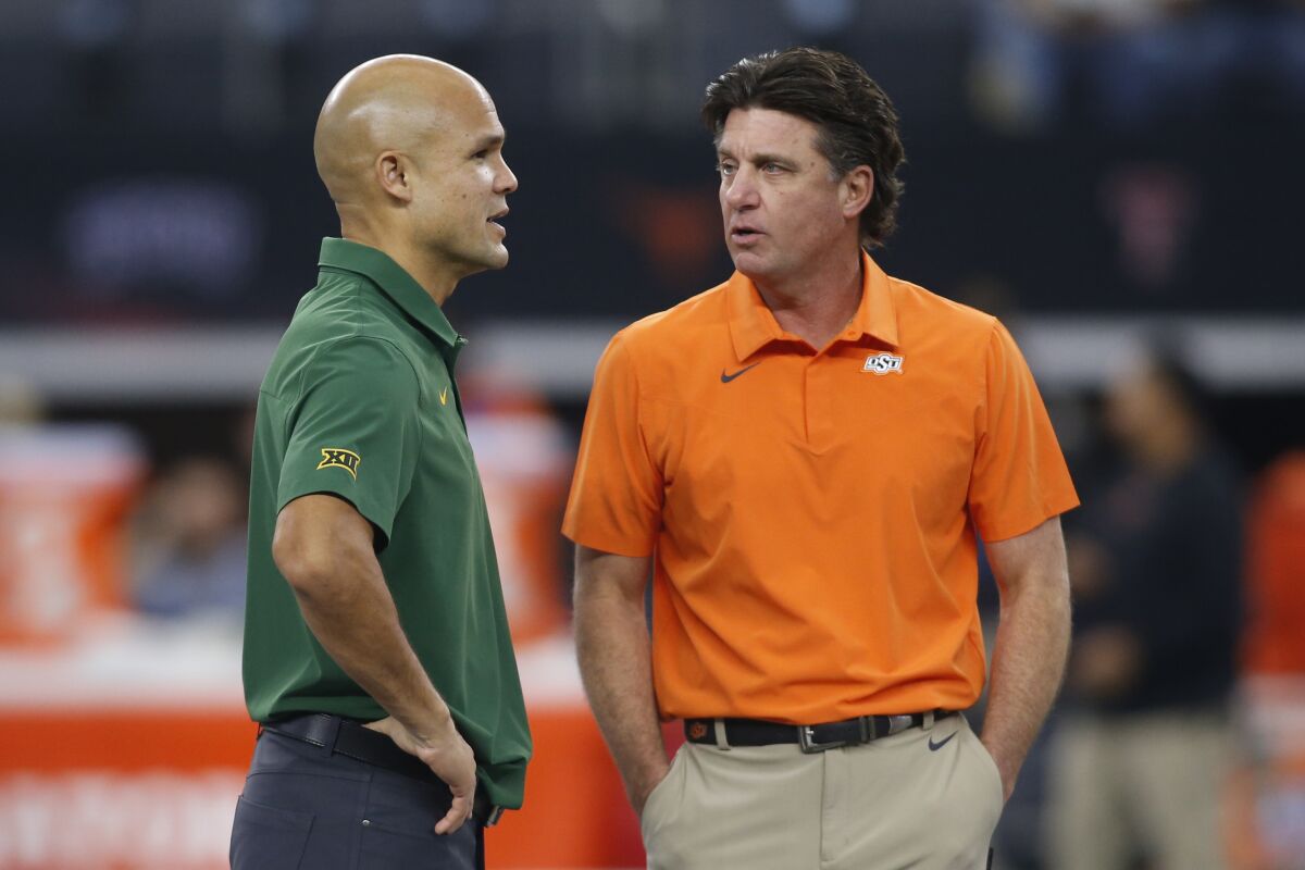 Baylor head coach Dave Aranda, left, talks to Oklahoma State head coach Mike Gundy, before an NCAA college football game for the Big 12 Conference championship in Arlington, Texas, Saturday, Dec. 4, 2021. (AP Photo/Tim Heitman)