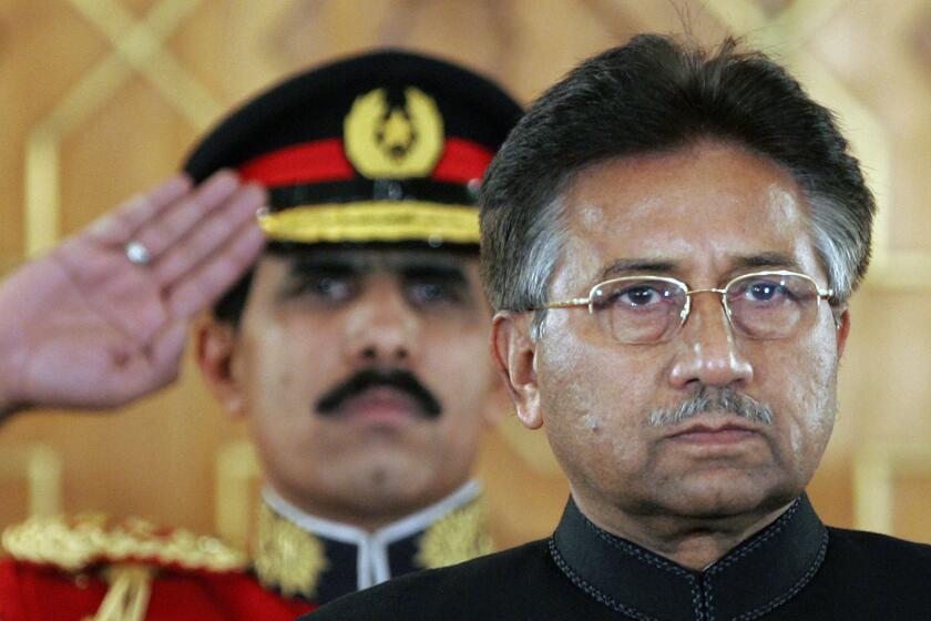 FILE - Pakistan's President Pervez Musharraf listens to the national anthem before being sworn in as the country's civilian president at President House in Islamabad, Pakistan on Nov. 29, 2007. An official said Sunday, Feb. 5, 2023, Gen. Pervez Musharraf, Pakistan military ruler who backed US war in Afghanistan after 9/11, has died. (AP Photo/B.K.Bangash, File)