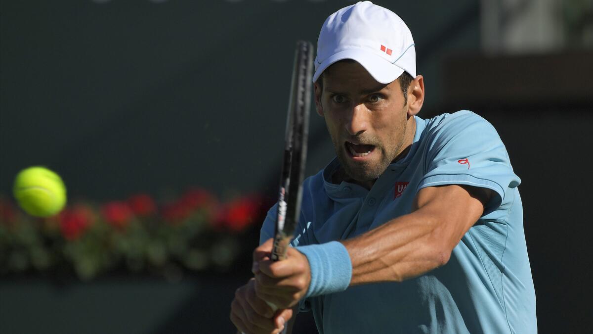 Novak Djokovic returns a shot to Nick Kyrgios during their match Wednesday in the BNP Paribas Open.