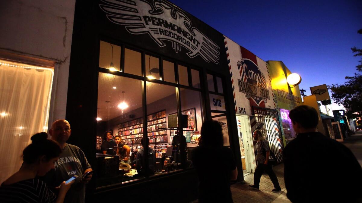 A group of people wait for a band to perform at Permanent Records on York Boulevard.