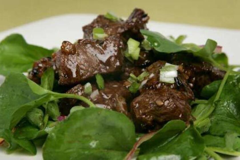 ONE-DISH MEAL: Hot, sautéed beef over a cool watercress salad.