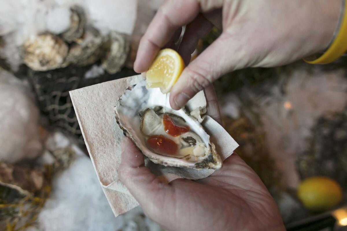 Water Grill serves Baywater sweet oysters with a cocktail sauce.