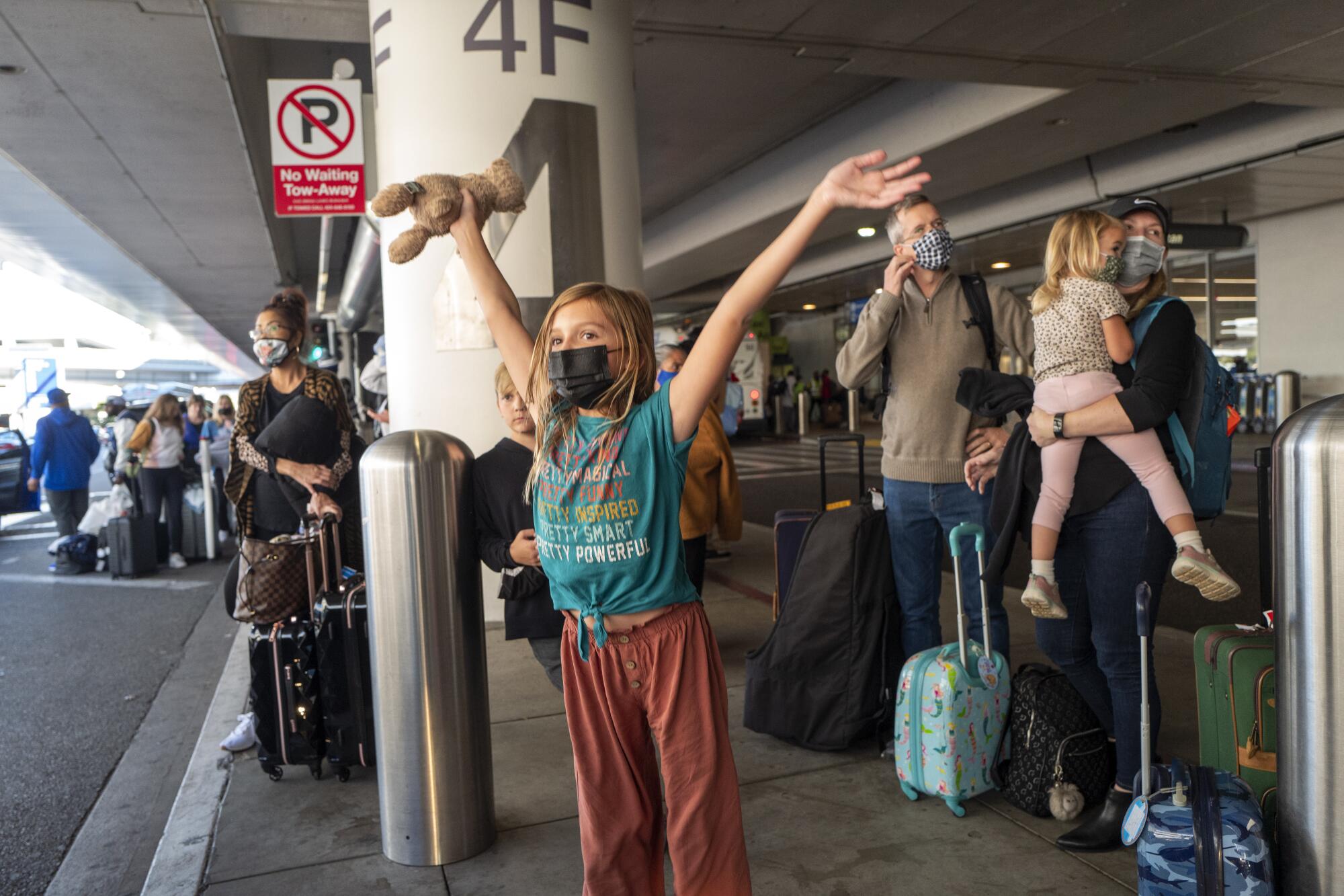 A 10-year-old girl in a mask outside LAX