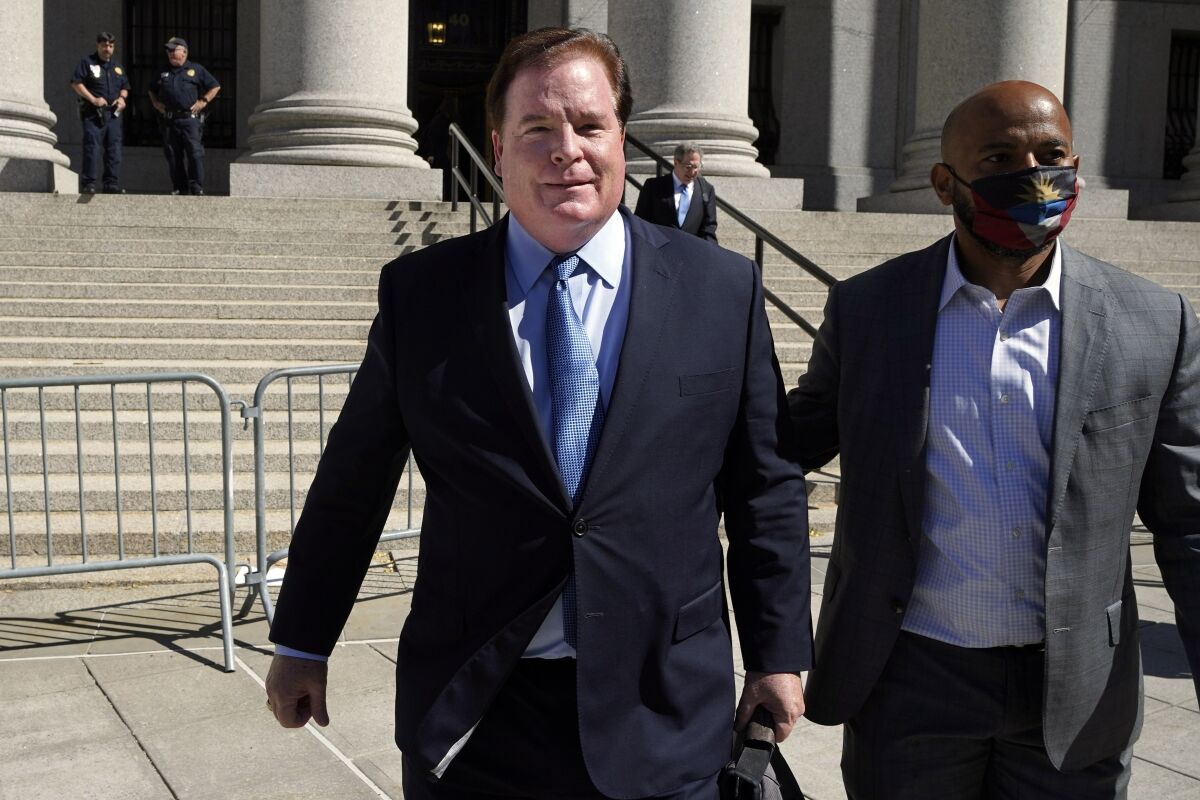 FILE — Chicago banker Stephen Calk, left, leaves federal court in New York, June 24, 2021. On Monday, Feb. 7, 2022, he was sentenced to a year in prison for his conviction in a scheme to make $16 million in loans to Paul Manafort to gain influence in the Trump administration. (AP Photo/Richard Drew, File)