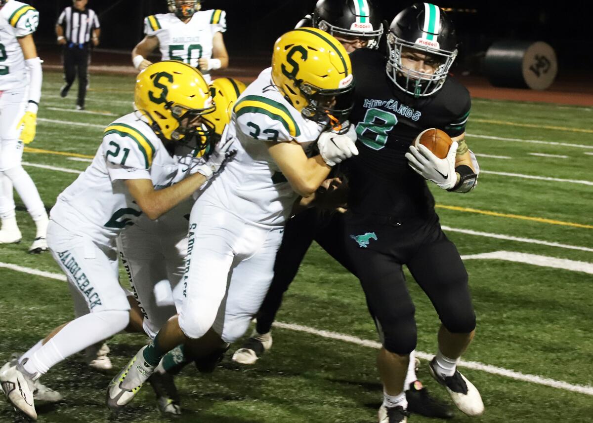 Costa Mesa's Ethan Smithlin (8) gets yardage on a punt return against Saddleback in an Orange Coast League game on Friday.