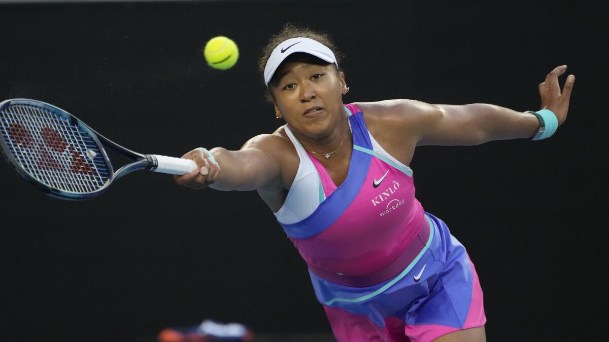 Naomi Osaka plays a forehand return to Amanda Anisimova.