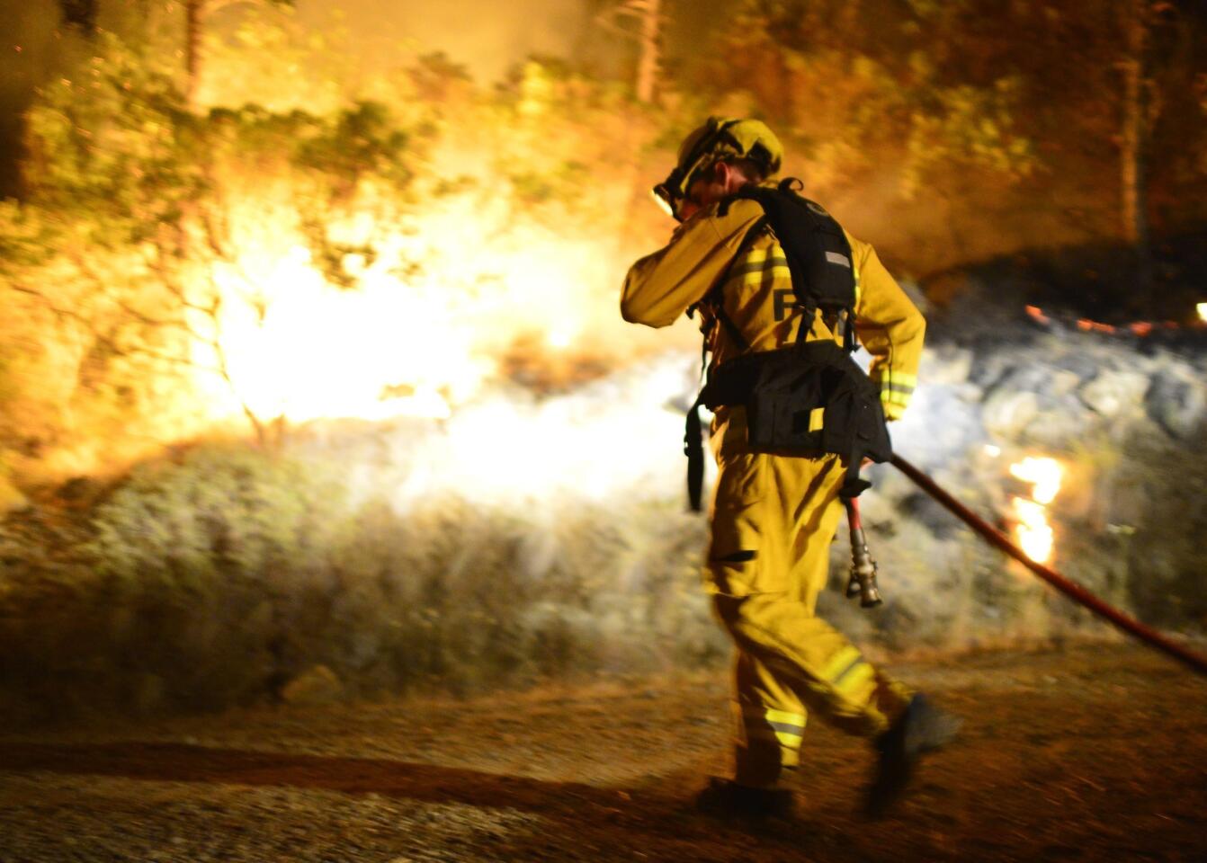 A firefighter manages a back burn set to protect homes at the Butts Fire in Napa County on Wednesday.