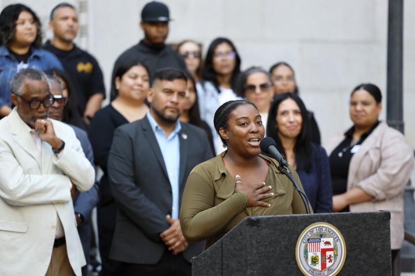 Los Angeles, CA - July 30: L.A. City Councilmembers Curren D. Price, Jr., left, and Hugo Soto-Martinez, second from left, listen to program participant Ashley Davis, who is a mother of a special needs child, speak at a press conference to unveil the results from a pilot program called "Basic Income Guaranteed: Los Angeles Economic Assistance Pilot (BIG:LEAP)" at Los Angeles City Hall in Los Angeles Tuesday, July 30, 2024. The 12-month, anti-poverty program gave $1,000 a month cash to some of the poorest families in L.A.. The council members appeared outside City Hall Tuesday morning with participants in the program. (Allen J. Schaben / Los Angeles Times)
