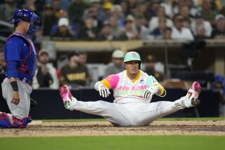 San Diego Padres' Manny Machado, right, falls after an inside pitch as Chicago Cubs catcher Yan Gomes looks on during the ninth inning of a baseball game Friday, June 2, 2023, in San Diego. (AP Photo/Gregory Bull)