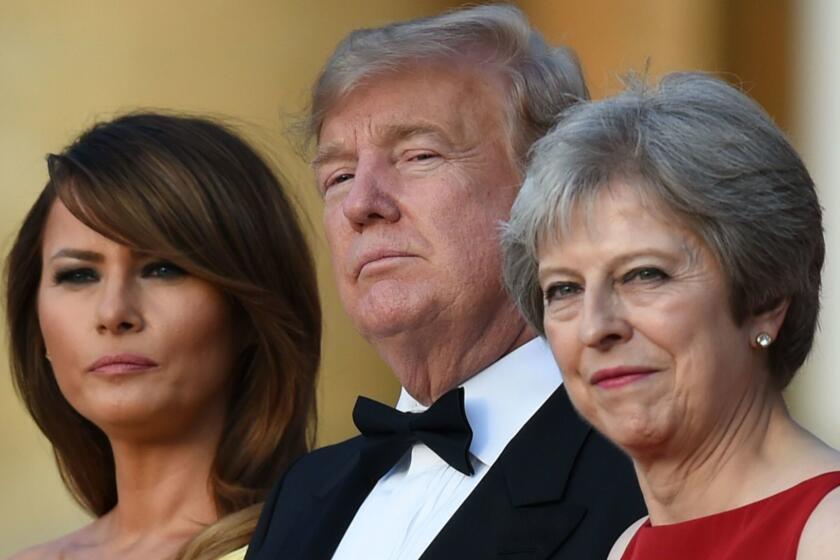 (L-R) US First Lady Melania Trump, US President Donald Trump and Britain's Prime Minister Theresa May stand on steps in the Great Court as the bands of the Scots, Irish and Welsh Guards perform a ceremonial welcome as they arrive for a black-tie dinner with business leaders at Blenheim Palace, west of London, on July 12, 2018, on the first day of President Trump's visit to the UK. The four-day trip, which will include talks with Prime Minister Theresa May, tea with Queen Elizabeth II and a private weekend in Scotland, is set to be greeted by a leftist-organised mass protest in London on Friday. / AFP PHOTO / POOL / Geoff PUGHGEOFF PUGH/AFP/Getty Images ** OUTS - ELSENT, FPG, CM - OUTS * NM, PH, VA if sourced by CT, LA or MoD **