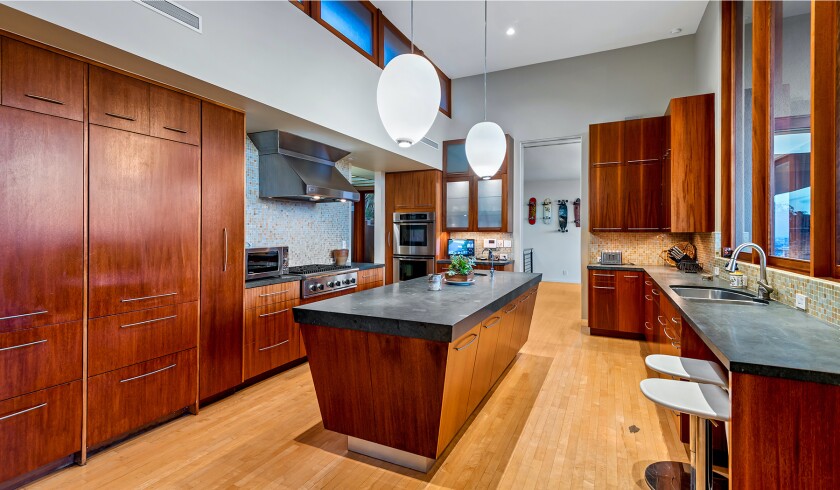 The hillside home includes three levels of decks, balconies and patios, as well as a swimming pool and spa.