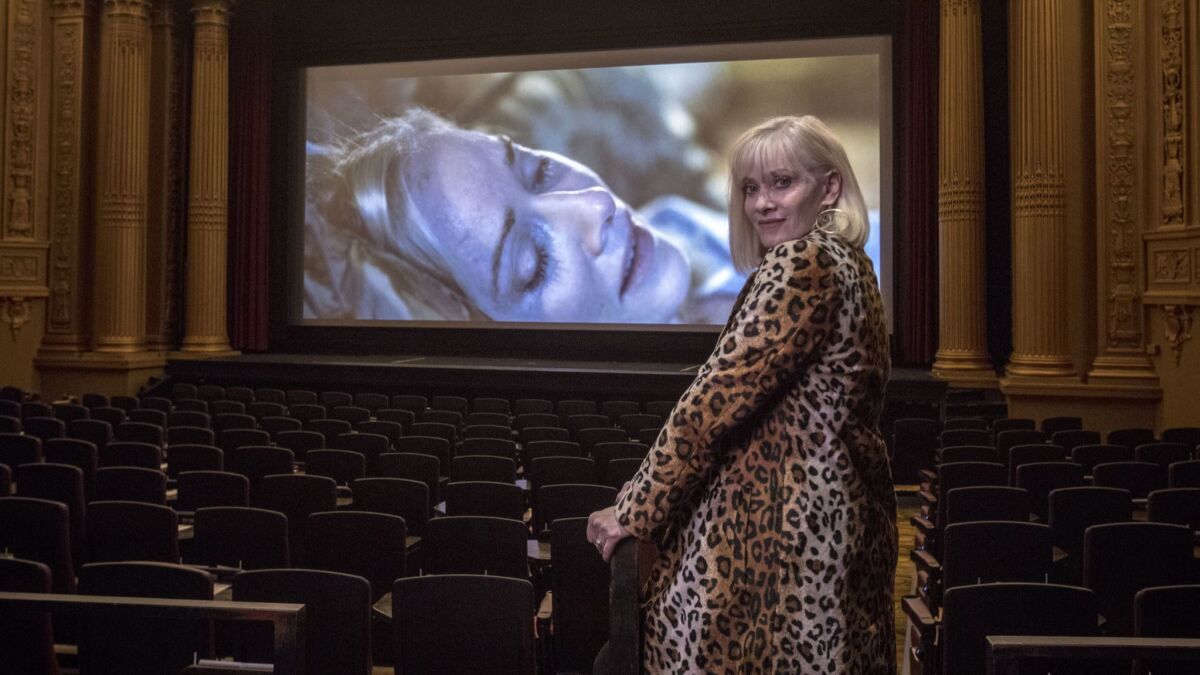 Horror film icon Barbara Crampton, who starred in the cult classic "Re-Animator," seen here at the Alamo Drafthouse Cinema in San Francisco with herself on the screen in the 2011 movie "You're Next."