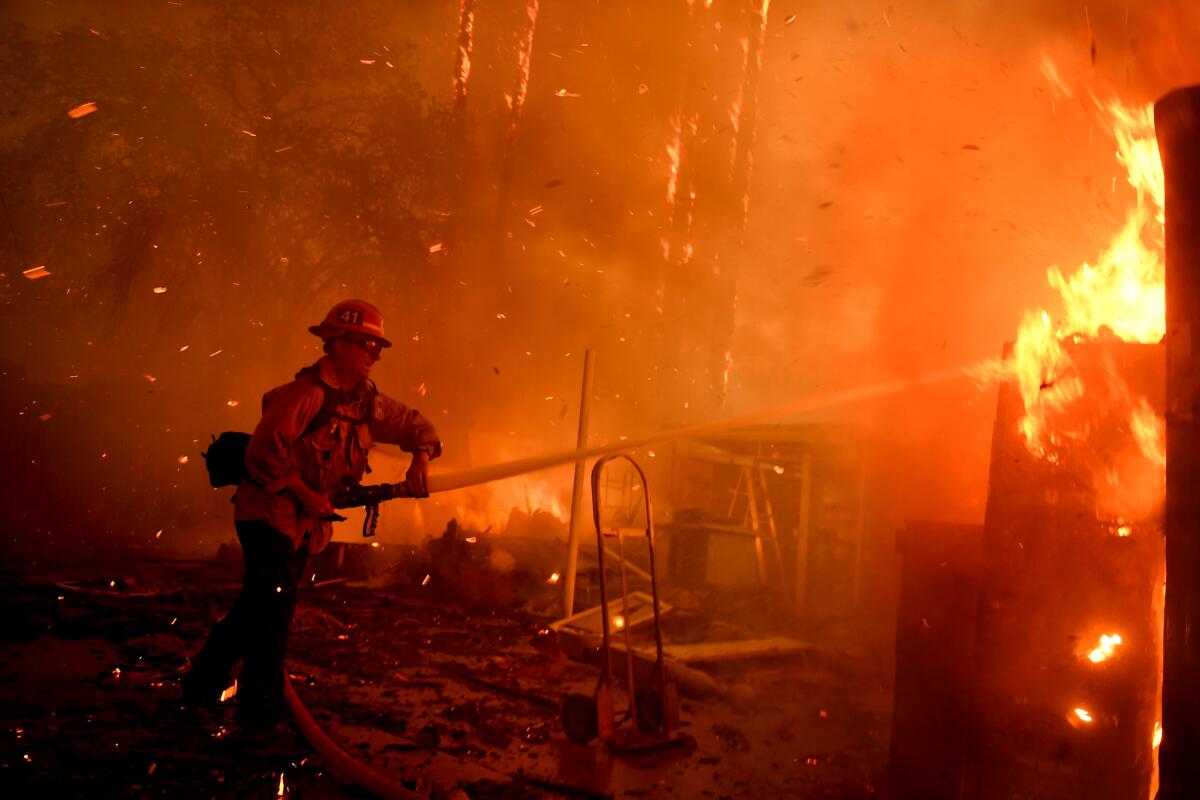 A firefighter battles the Thomas fire along Highway 33 in Casita Springs in Ventura County.