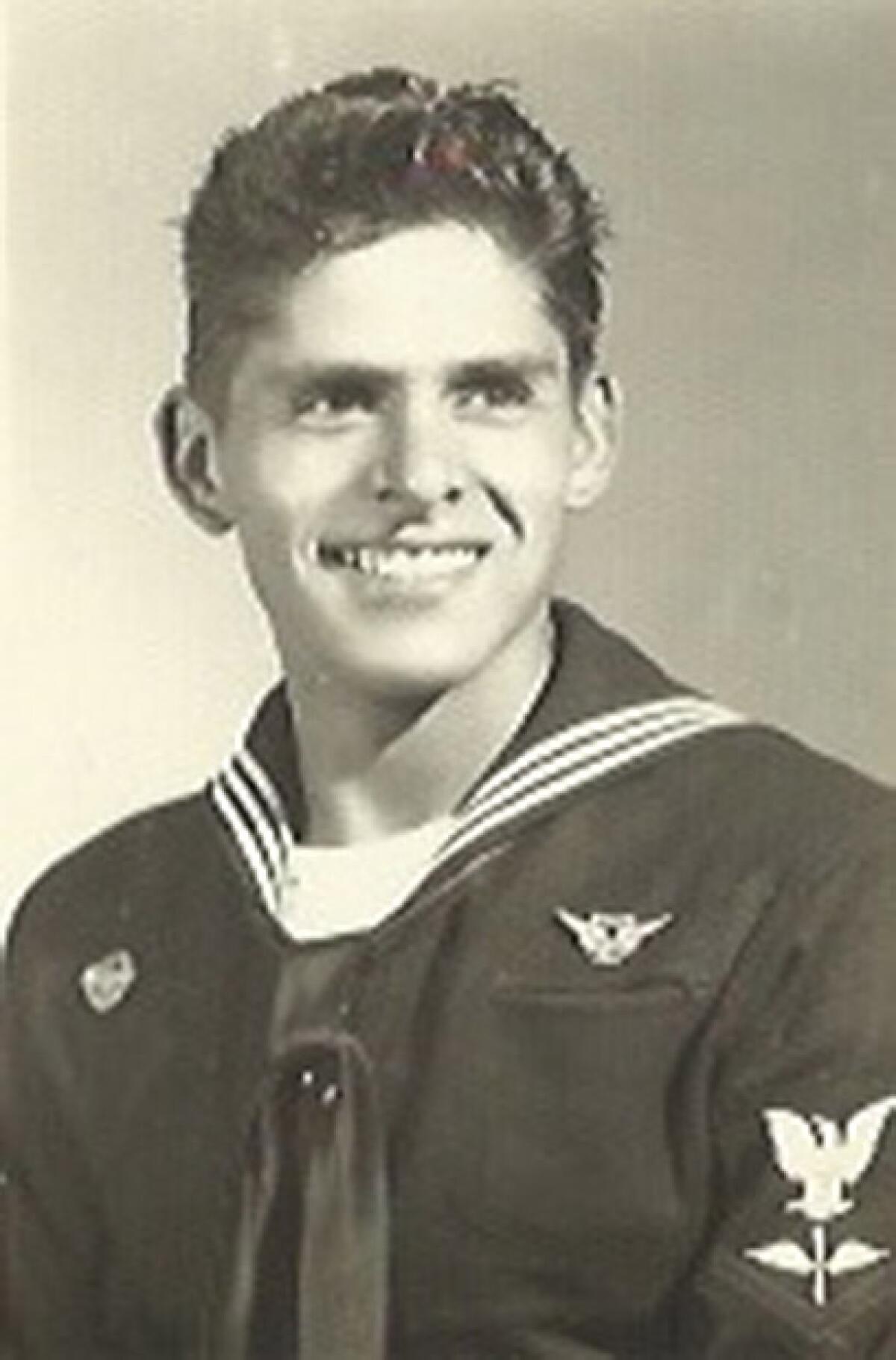 A young Julian Nava smiles in his Navy uniform