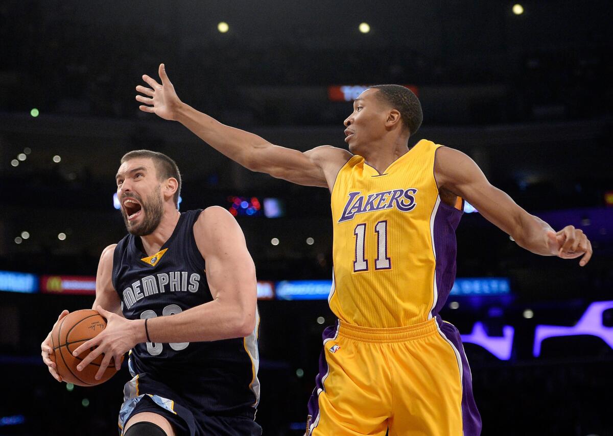 Memphis' Marc Gasol drives to the basket under the arm of Lakers' Wesley Johnson at Staples Center on Wednesday night.