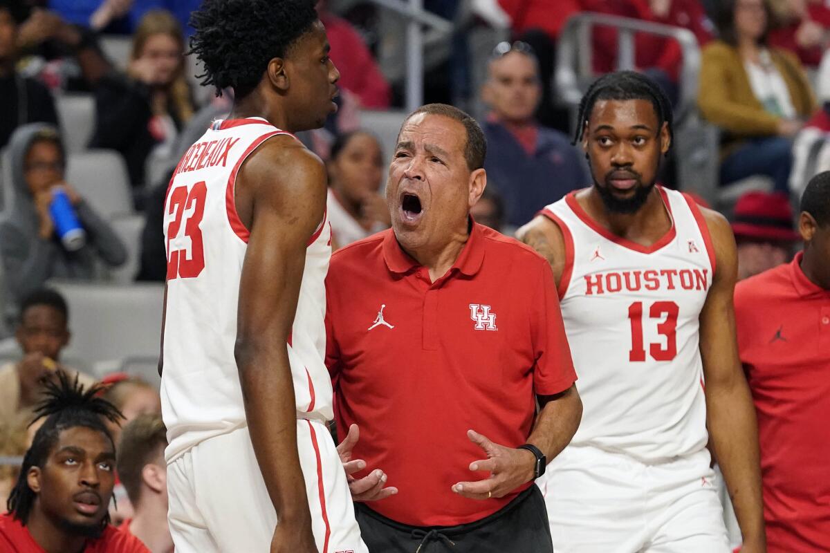 Houston coach Kelvin Sampson yells at guard Terrance Arceneaux as forward J'Wan Roberts looks on.