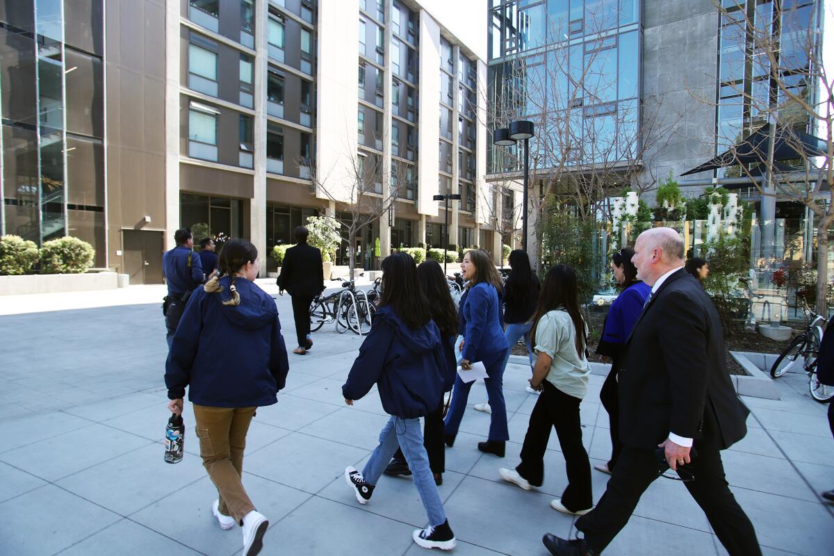 California Lt. Gov. Eleni Kounalakis walks with UC Irvine students during a tour of the Mesa Court towers on Monday.