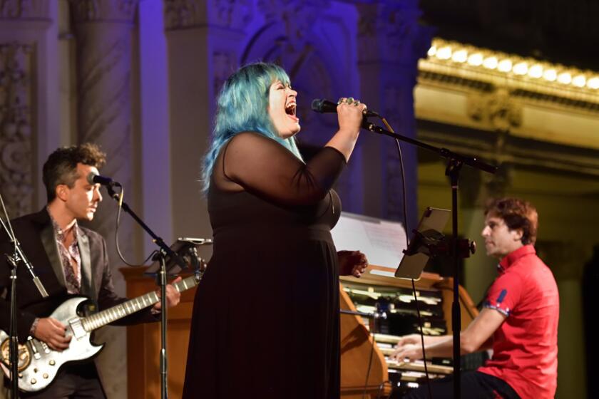 Chloe Lou Liddell performing with a rock band at the Spreckels Organ Pavilion in Balboa Park.