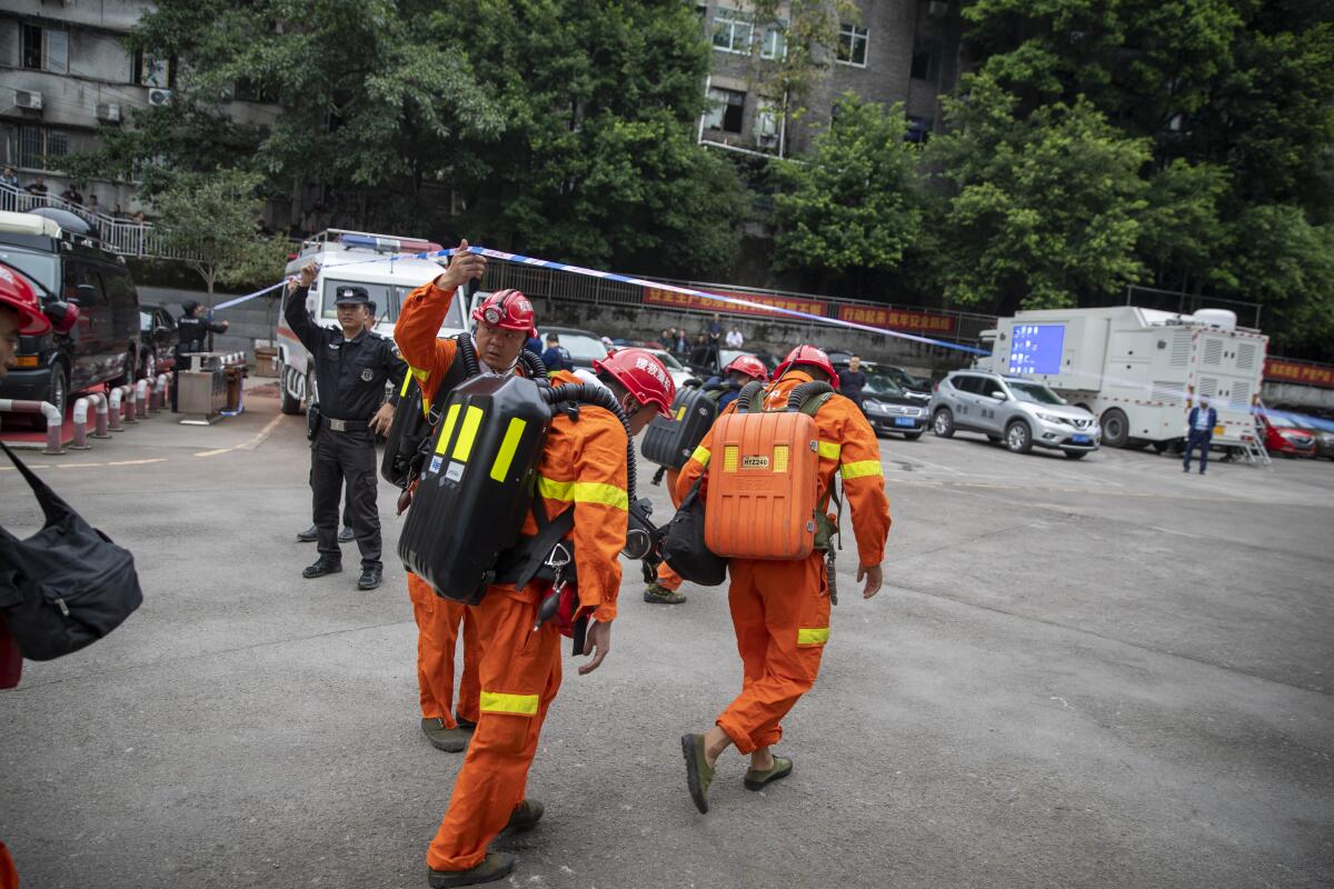 Rescuers arrive at a coal mine in Chongqing, China, on Sunday.