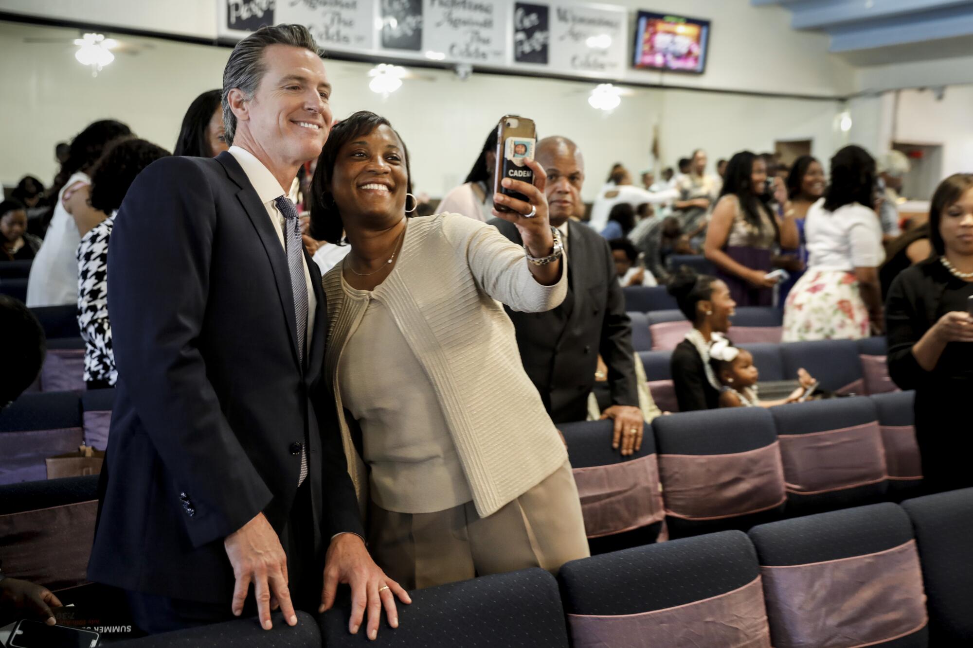 Laphonza Butler and then-California Democratic candidate for governor Lt. Gov. Gavin Newsom take a selfie.