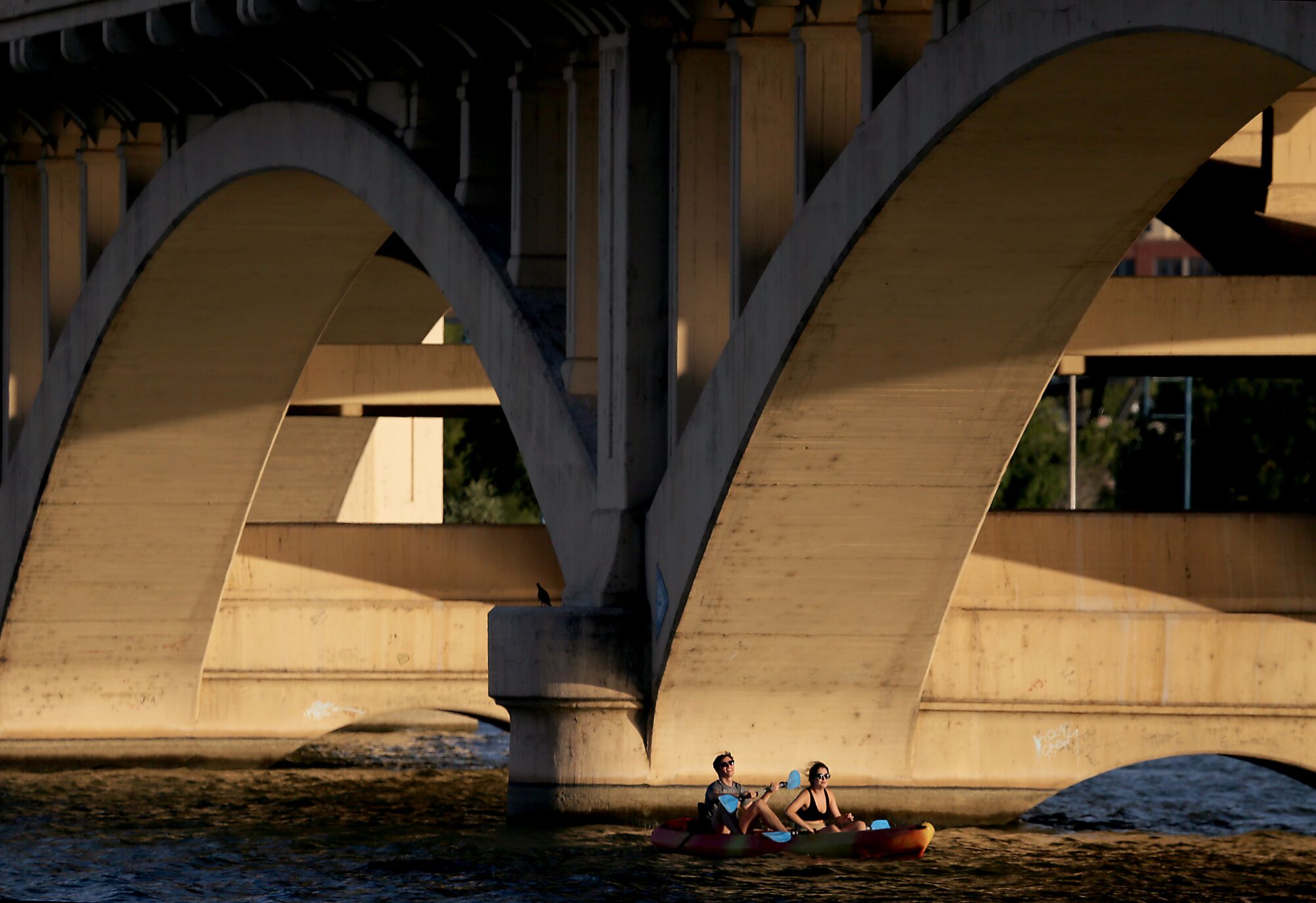 Kayakers navigate Tempe Town Lake, an artificial body of water that contains Colorado River water.
