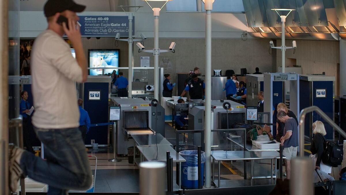 Passengers go through security at Terminal 4 at Los Angeles International Airport. The Transportation Security Administration has been testing a new screening procedure at LAX and nine other airports.