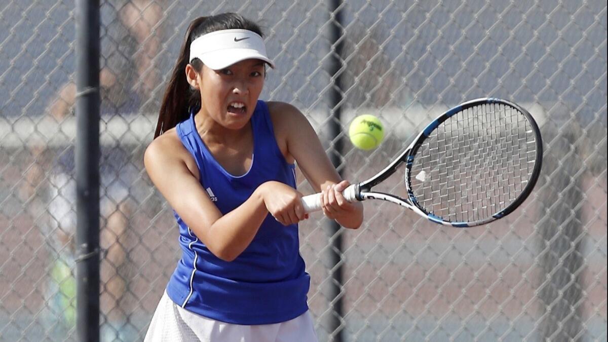Fountain Valley High's Ivy Tran competes against Huntington Beach during a No. 2 singles set of a Sunset Conference crossover match on Thursday.